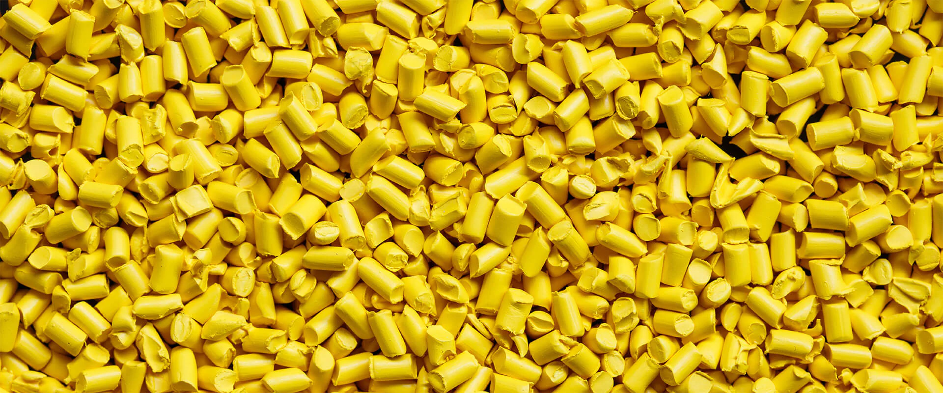 MiT Bildbeschreibung / description: Gelbe Kunststoffgranulate für die industrielle Verarbeitung.